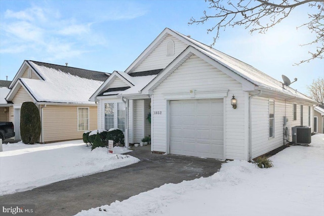 view of front of property with central AC unit and a garage