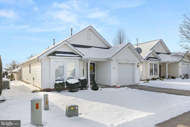 view of front facade with central AC and a garage