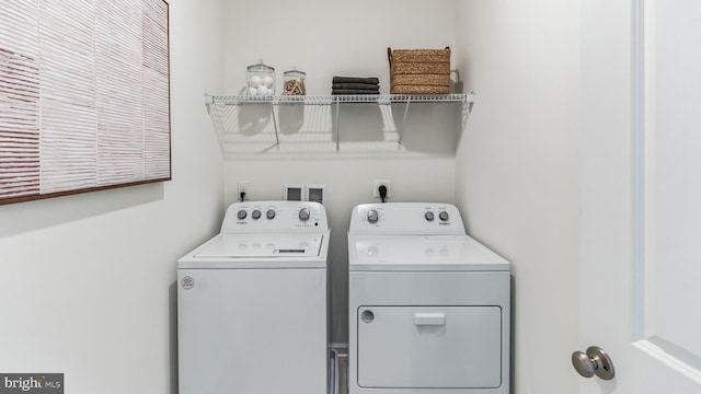 washroom with washing machine and clothes dryer