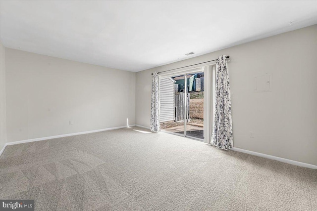 carpeted empty room with visible vents and baseboards