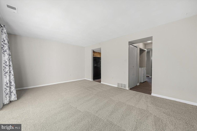 unfurnished room featuring visible vents, carpet flooring, and baseboards