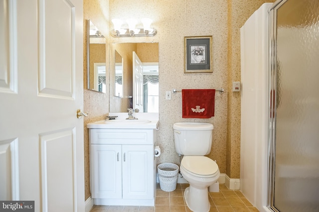 bathroom featuring tile patterned flooring, vanity, an enclosed shower, and toilet