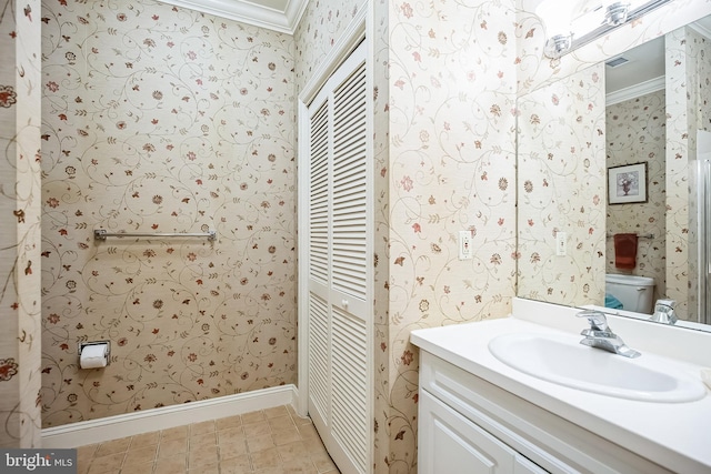 bathroom featuring vanity, crown molding, and toilet