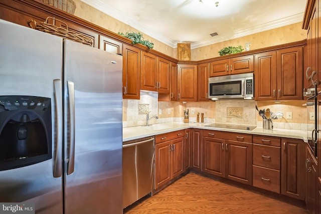 kitchen featuring tasteful backsplash, sink, light stone counters, stainless steel appliances, and crown molding