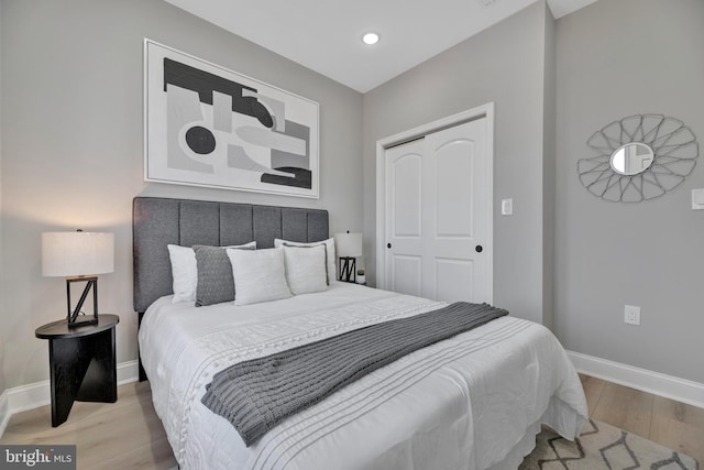 bedroom with a closet and light hardwood / wood-style floors