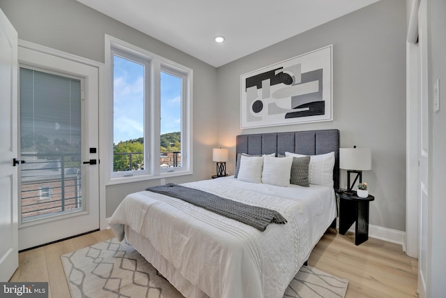 bedroom with access to outside and light hardwood / wood-style floors