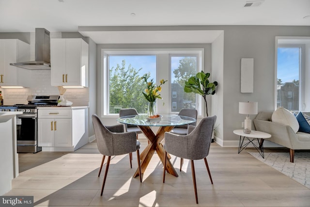 dining area with light hardwood / wood-style floors