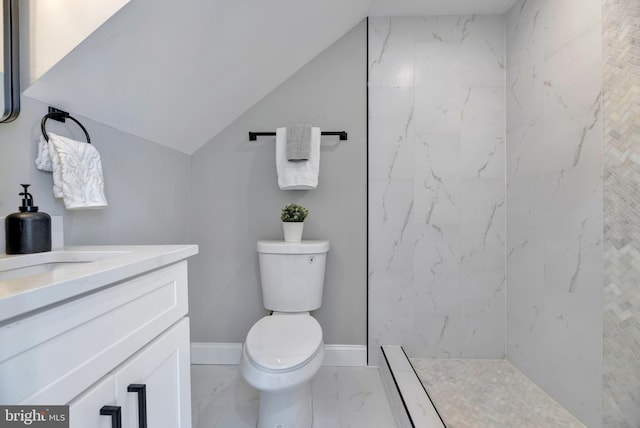 bathroom featuring vanity, toilet, and tiled shower