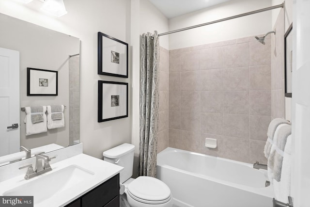 full bathroom featuring shower / bath combination with curtain, vanity, and toilet