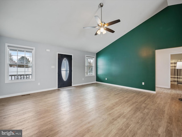 unfurnished living room with hardwood / wood-style flooring, ceiling fan, and vaulted ceiling