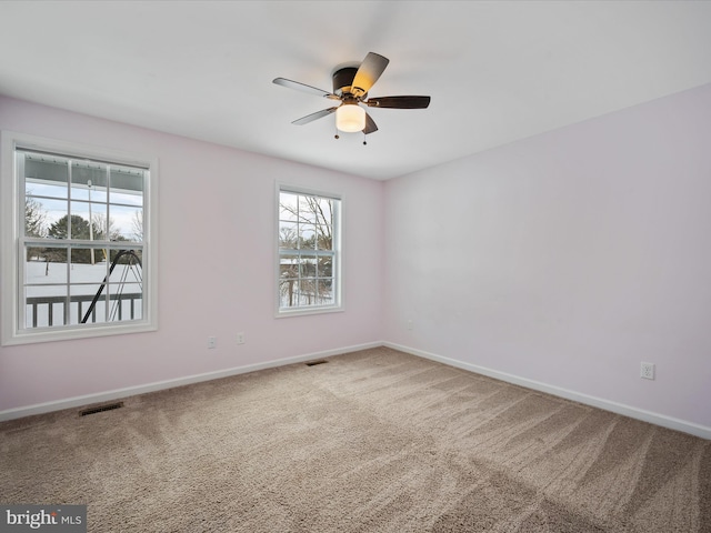 empty room featuring ceiling fan and carpet flooring