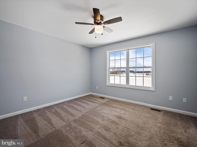 empty room featuring ceiling fan and carpet flooring