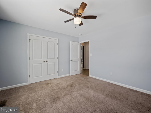 unfurnished bedroom featuring carpet floors, ceiling fan, and a closet