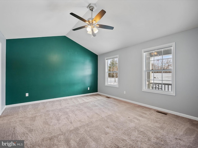 spare room with lofted ceiling, carpet floors, and ceiling fan