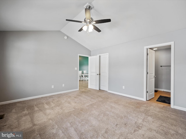 unfurnished bedroom with light carpet, vaulted ceiling, and ceiling fan