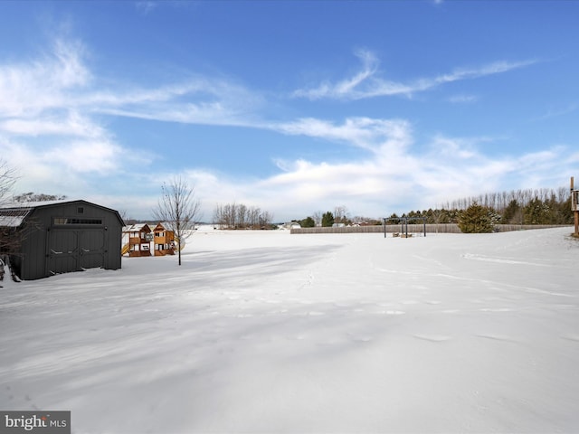 snowy yard with a storage unit