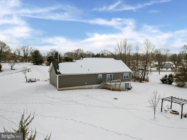 view of snow covered back of property