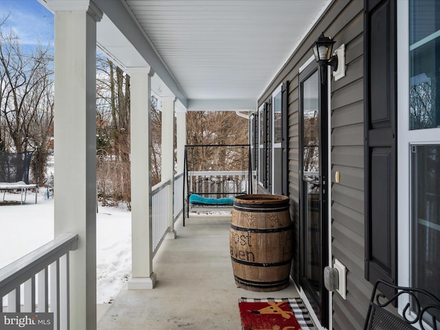 view of snow covered back of property