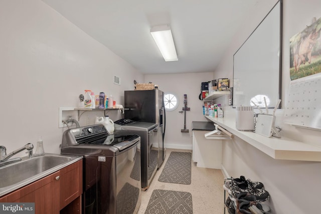 washroom with sink, separate washer and dryer, and cabinets