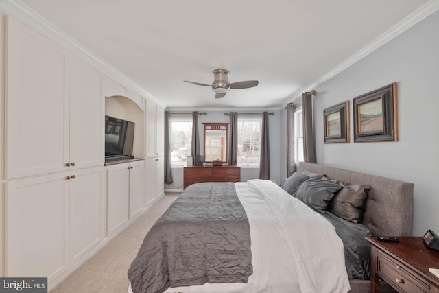 carpeted bedroom featuring ceiling fan and crown molding