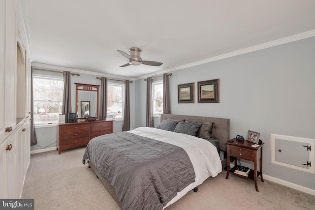 carpeted bedroom with ceiling fan and ornamental molding