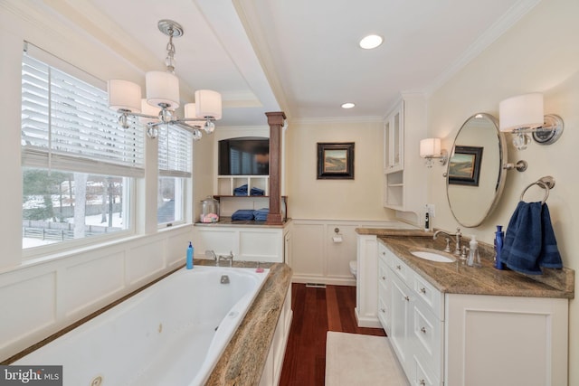 bathroom with toilet, hardwood / wood-style flooring, plenty of natural light, crown molding, and vanity