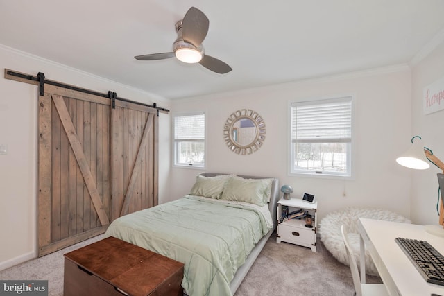 carpeted bedroom featuring ceiling fan, crown molding, and a barn door