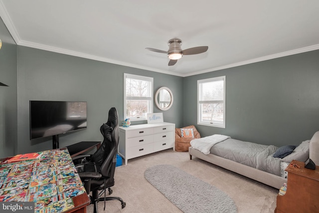 carpeted bedroom with ceiling fan and ornamental molding