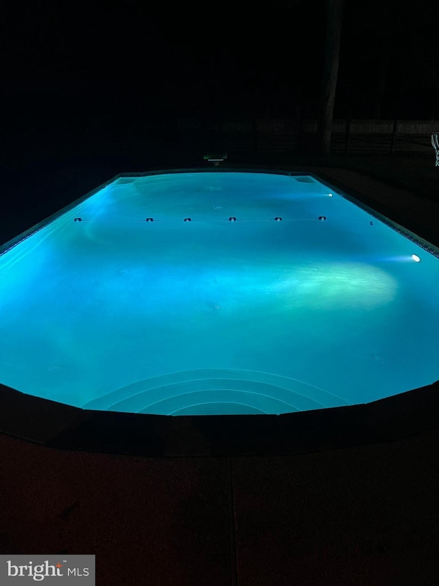 view of pool at night