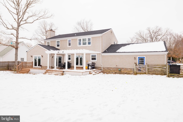 snow covered property featuring a pergola