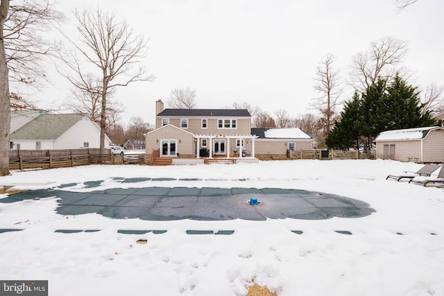 snow covered pool with a shed