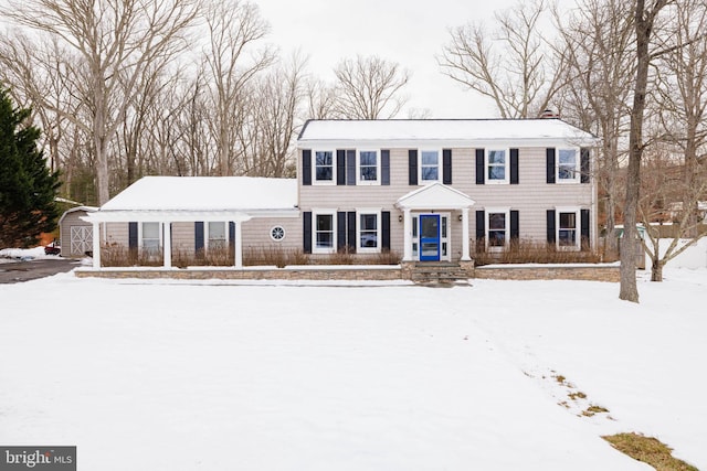 colonial-style house featuring a storage shed