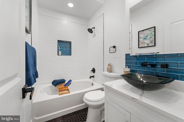 full bathroom with tiled shower / bath combo, vanity, tasteful backsplash, and toilet