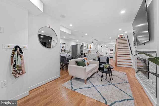 living room featuring sink and light wood-type flooring