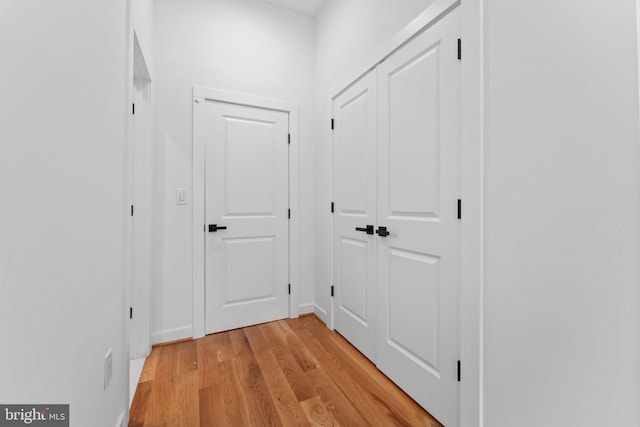 corridor with light wood-type flooring