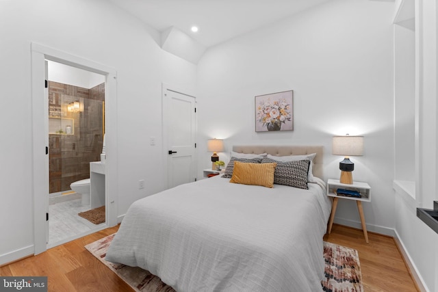 bedroom featuring ensuite bath and light wood-type flooring