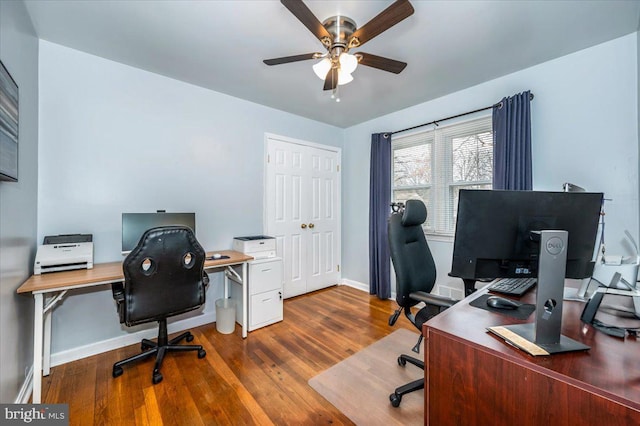 office area with wood finished floors, a ceiling fan, and baseboards