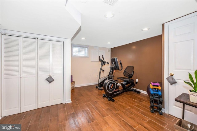 workout room featuring baseboards, wood finished floors, and recessed lighting