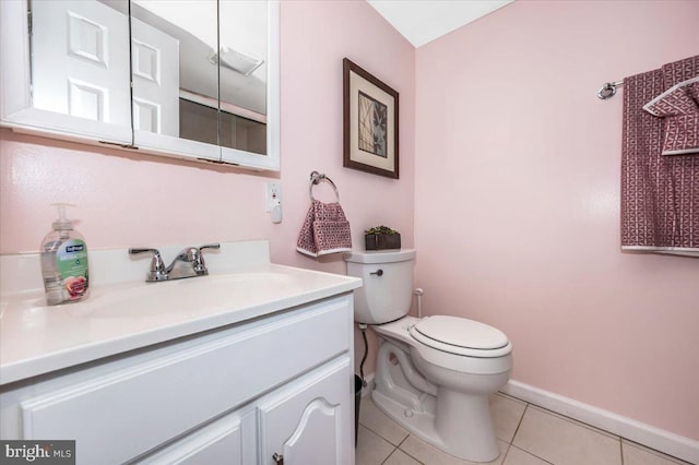 bathroom with toilet, tile patterned flooring, baseboards, and vanity