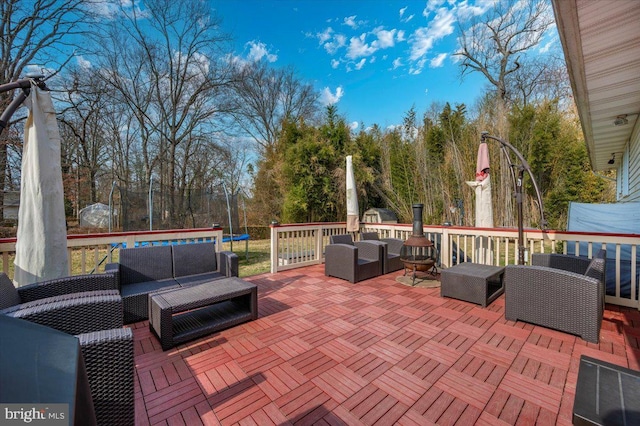 view of patio with a trampoline and an outdoor living space