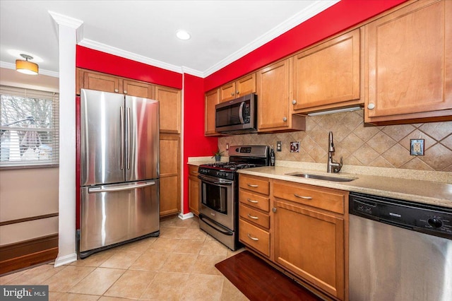 kitchen featuring light tile patterned floors, a sink, light countertops, appliances with stainless steel finishes, and brown cabinetry