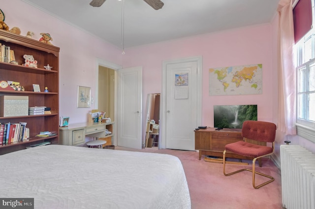 carpeted bedroom featuring radiator and ceiling fan