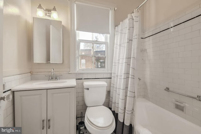 full bathroom with toilet, vanity, shower / tub combo with curtain, and tile walls