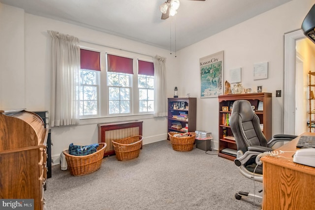 carpeted office space featuring ceiling fan