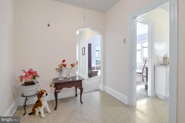 corridor featuring light tile patterned floors