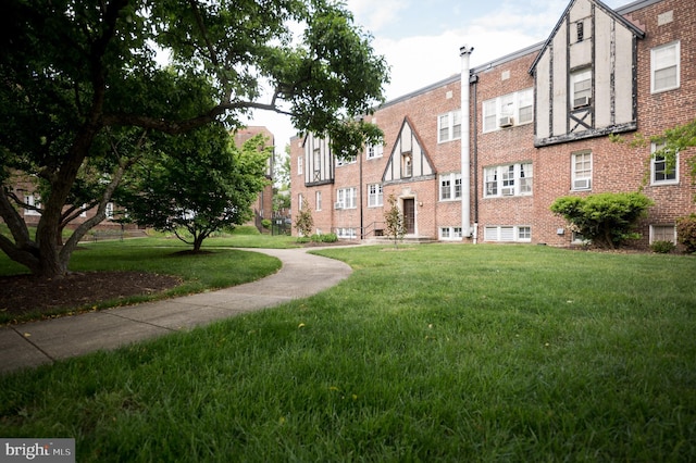 view of home's community with a yard