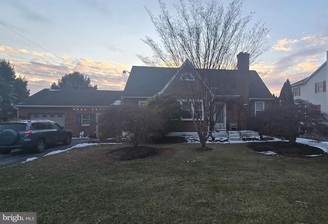 view of front of property with a yard and a garage