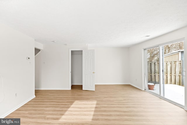 empty room with light hardwood / wood-style floors