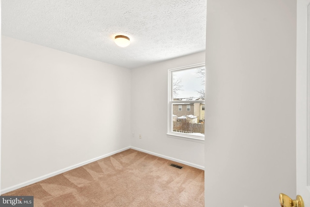 unfurnished room featuring carpet flooring and a textured ceiling