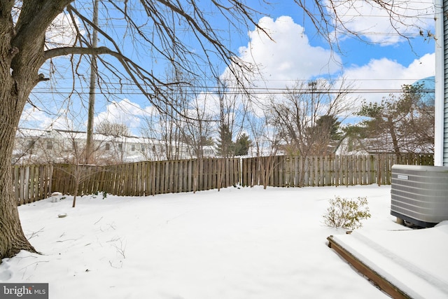 snowy yard featuring central AC unit